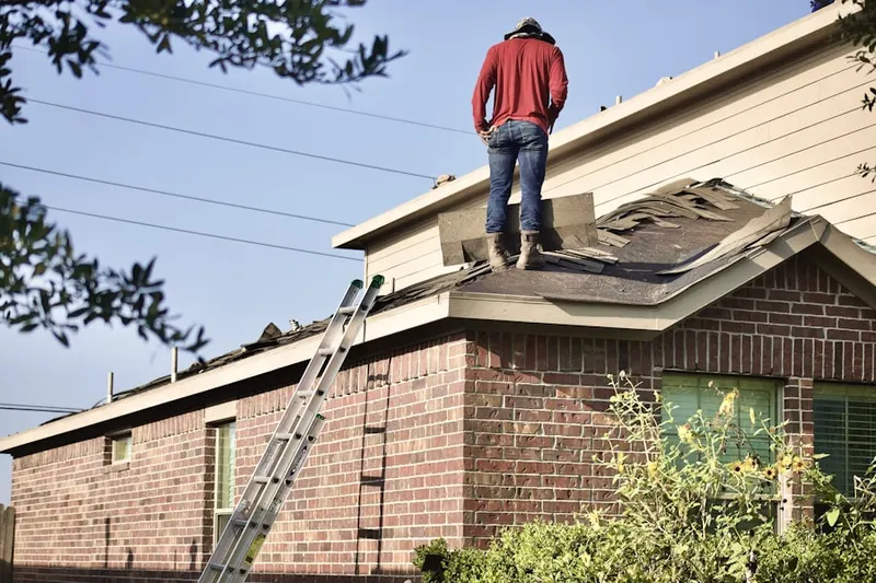 Professional roofer working on a residential roof in Hageman